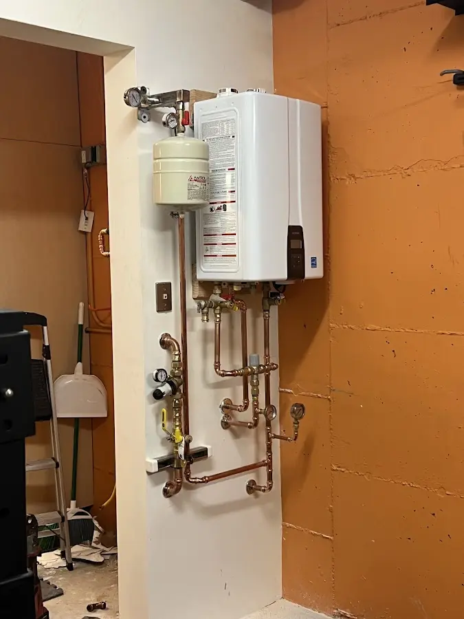 Plumbing technician inspecting water heater connections in Kissimmee